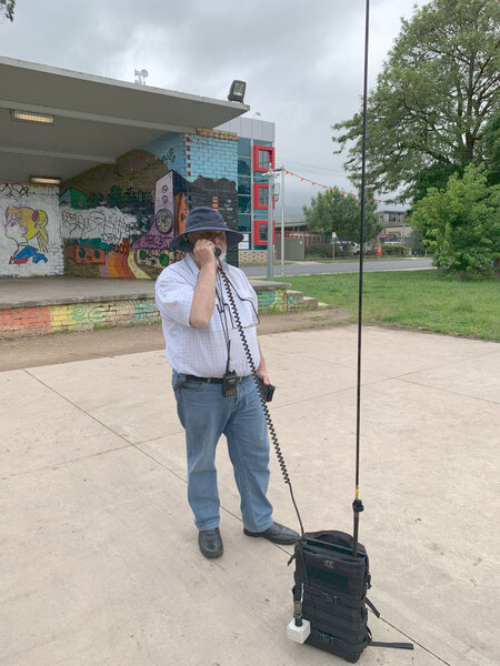 Picture of someone using a portable HF radio in a park